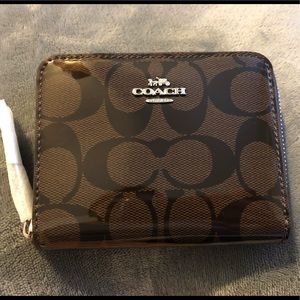 Coach small zip around wallet in signature patent